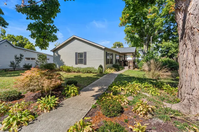 a front view of a house with a garden