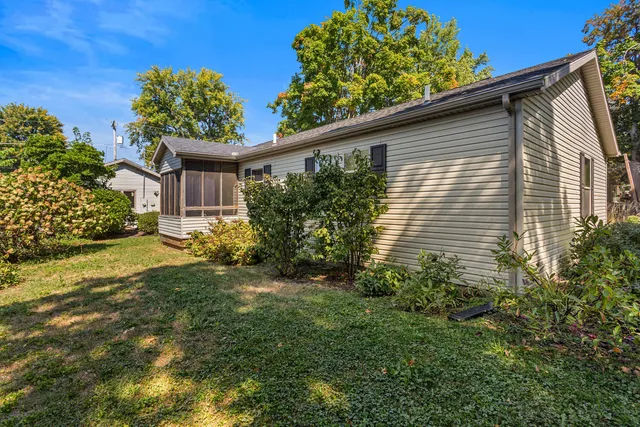 a yellow house with garden in front of it