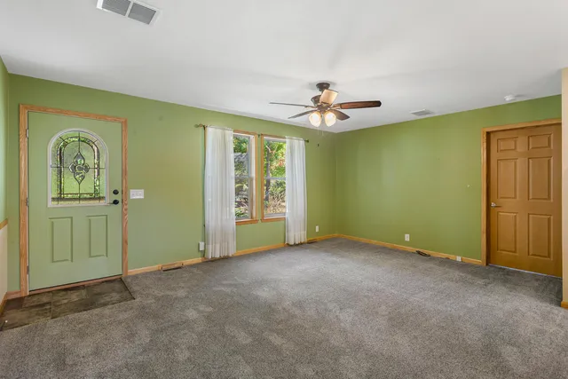 an empty room with windows and closet