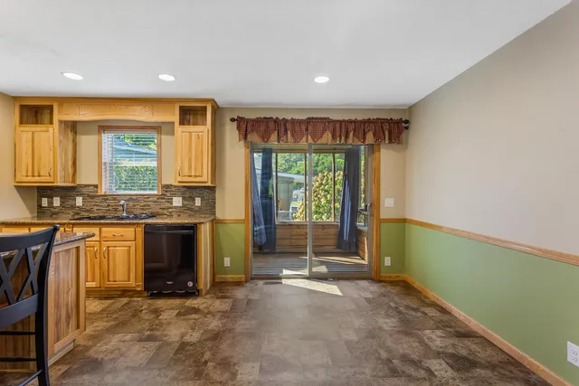 a view of a kitchen with a sink and a fireplace