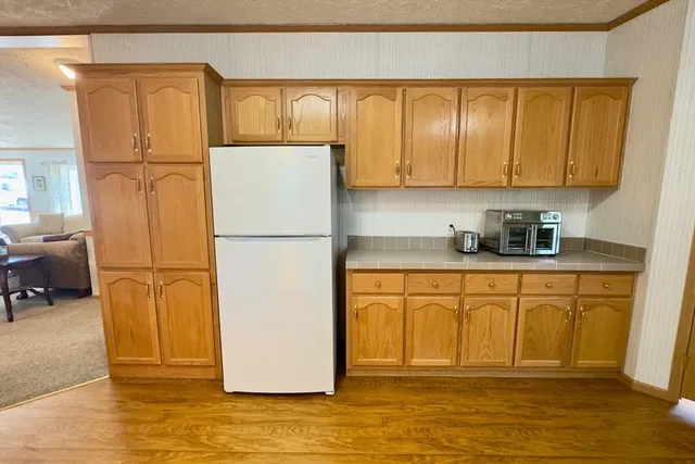 a white refrigerator freezer sitting in a kitchen