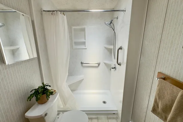 a bathroom with a shower and a toilet