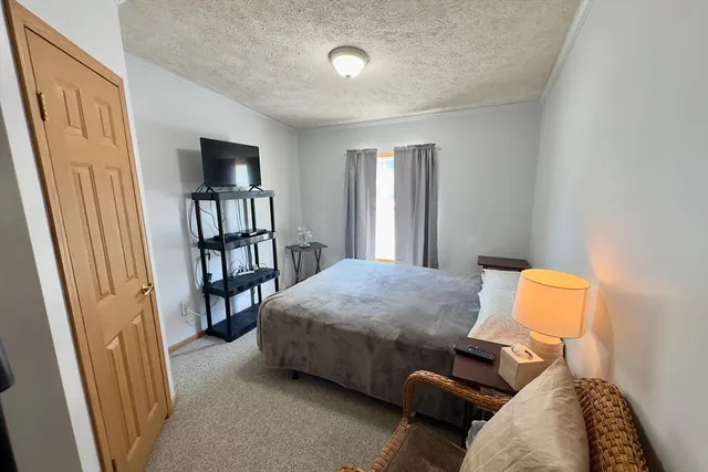 a bedroom with furniture and a book shelf