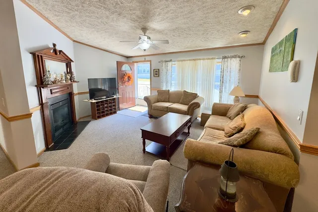 a living room with furniture a large window and a flat screen tv