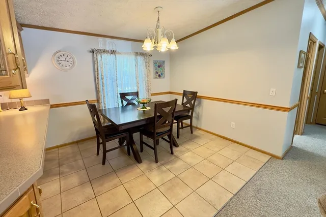 a view of a dining room with furniture and a chandelier