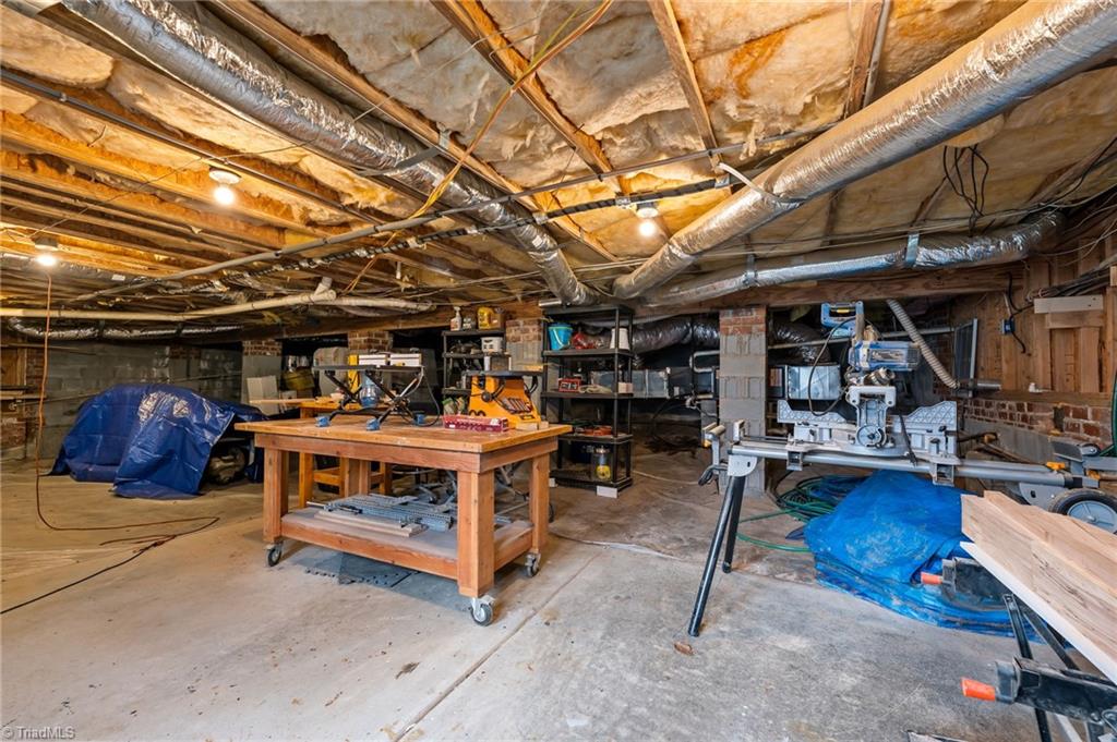 7602 Wilson Farm Road Summerfield, NC 27358 - Photo 30 of 50 Concrete floored oversized, tall crawlspace, used as a workshop