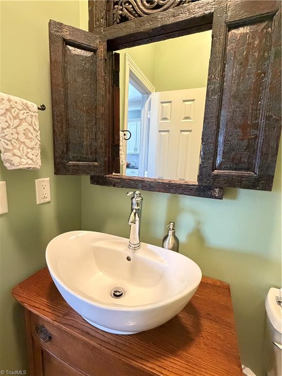 7602 Wilson Farm Road Summerfield, NC 27358 - Photo 48 of 50 Half bath with unique sink/cabinet
