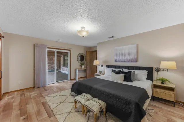 a bedroom with a large bed and a window