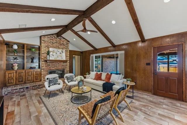 a dining room with furniture and wooden floor