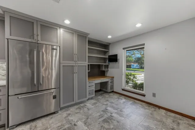 a view of a kitchen with a refrigerator and a sink