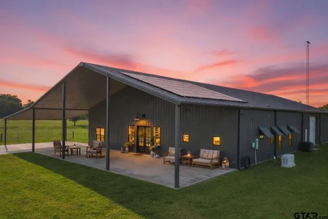 a backyard of a house with table and chairs