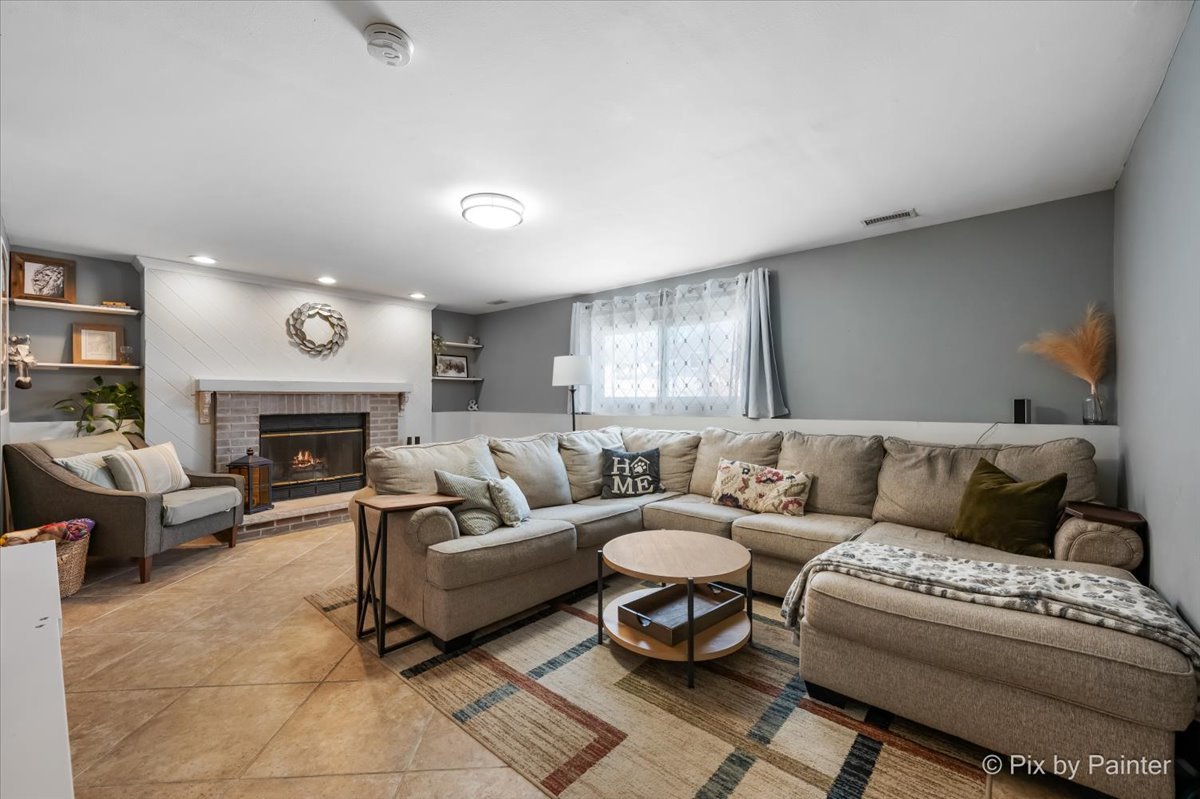 320 Homestead Drive Bolingbrook, IL 60440 - Photo 11 of 33 a living room with furniture and a fireplace