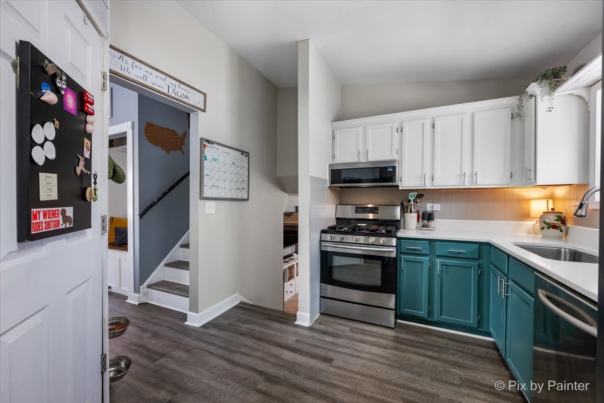 320 Homestead Drive Bolingbrook, IL 60440 - Photo 7 of 33 a kitchen with stainless steel appliances granite countertop a stove top oven a sink and dishwasher with wooden floor