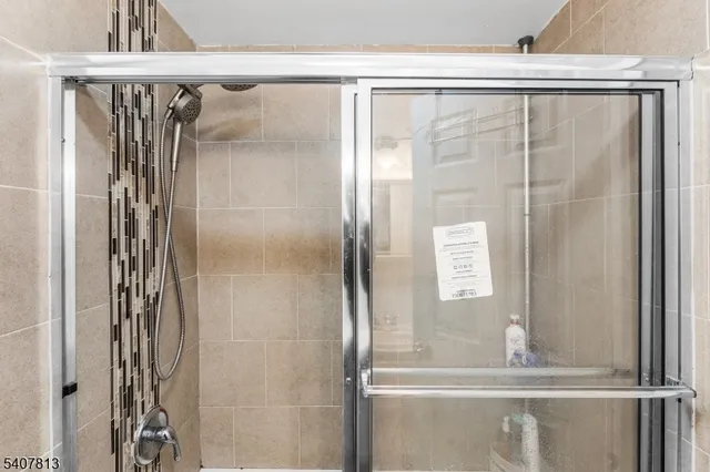 a bathroom with a glass shower door and a sink