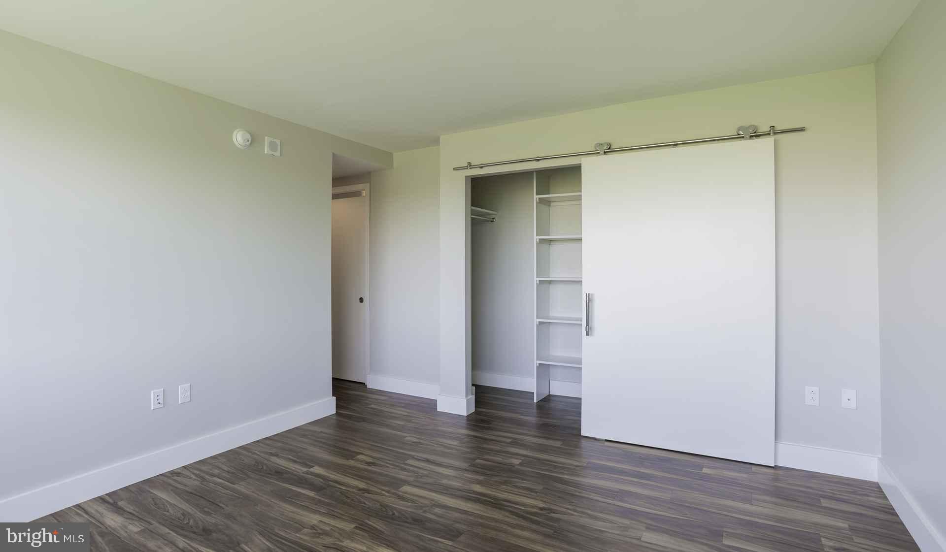 2200 Benjamin Franklin Parkway, Unit 1BN0910 Philadelphia, PA 19130 - Photo 7 of 19 a view of an empty room with wooden floor