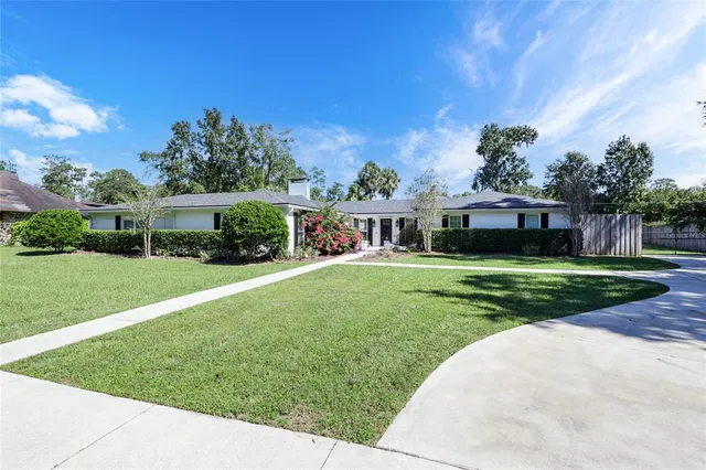 a front view of house with yard and green space