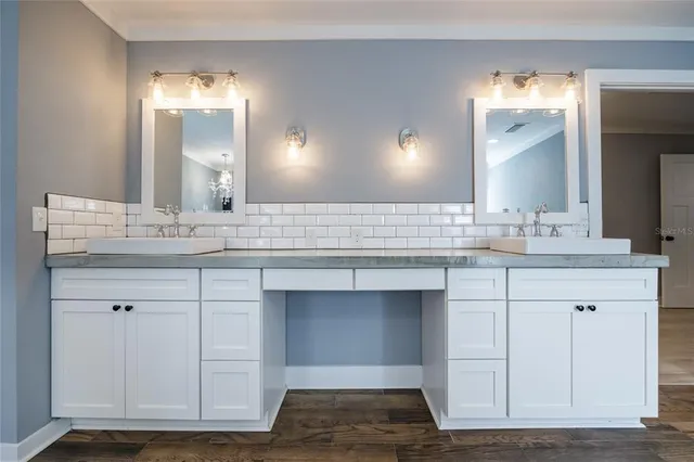 a bathroom with a sink vanity mirror and toilet