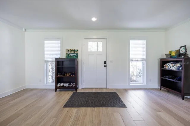 a living room with furniture rug and a window