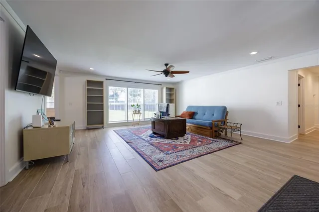 a kitchen with stainless steel appliances granite countertop a refrigerator a sink dishwasher a stove with wooden floors