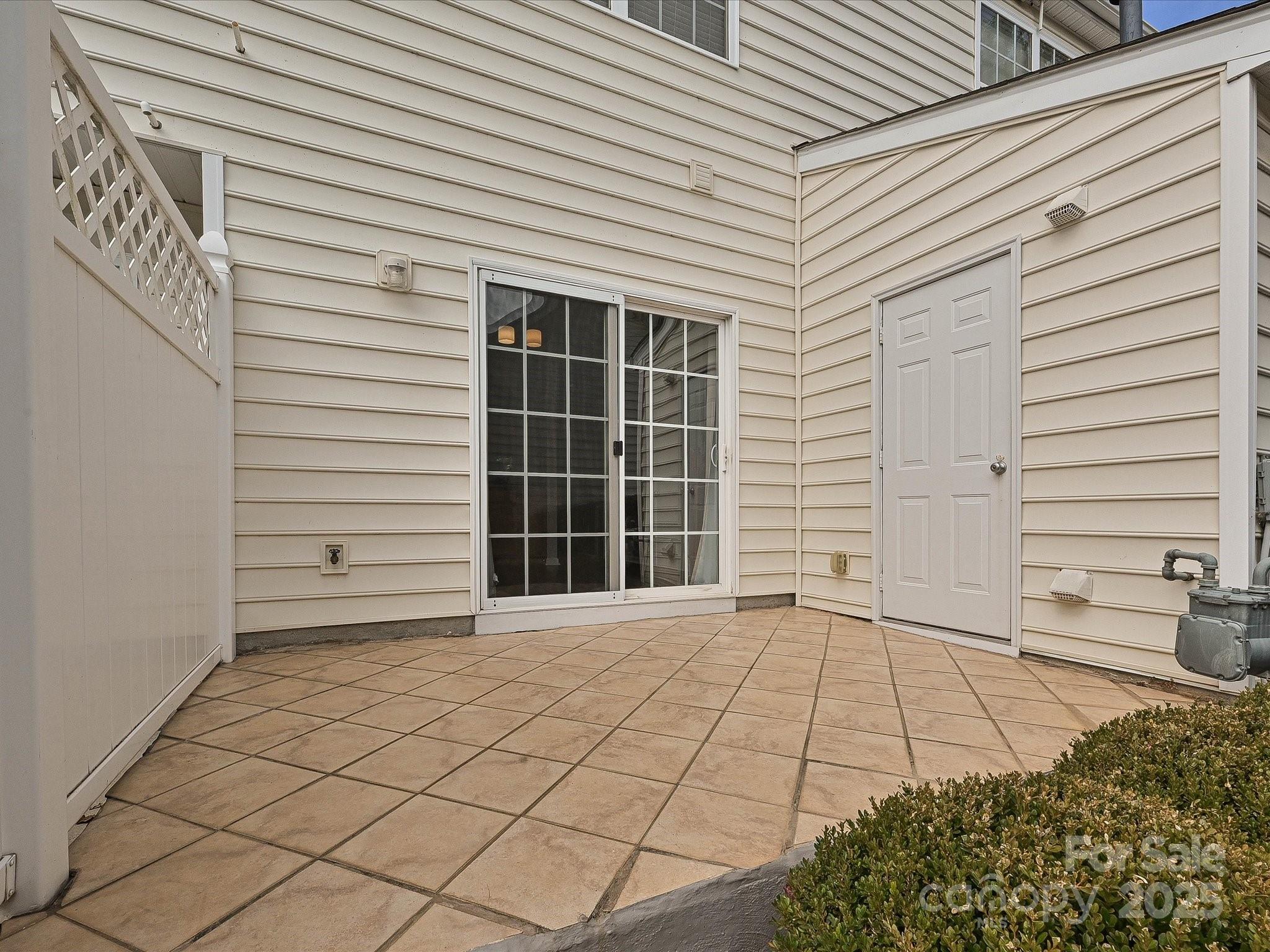 1115 Drummond Lane Matthews, NC 28104 - Photo 20 of 24 a view of a blue house with a large window