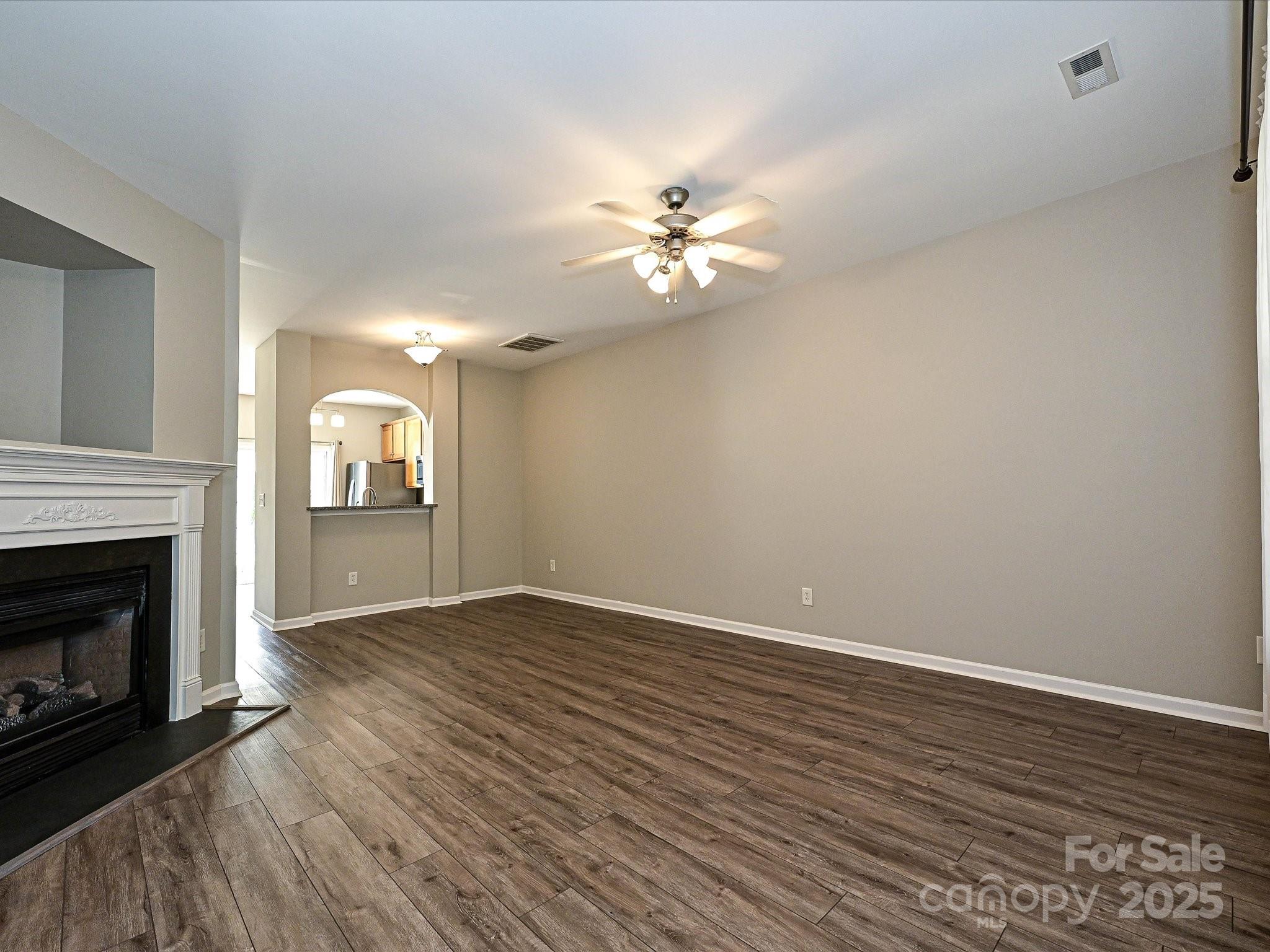 1115 Drummond Lane Matthews, NC 28104 - Photo 4 of 24 a view of empty room with wooden floor and fireplace