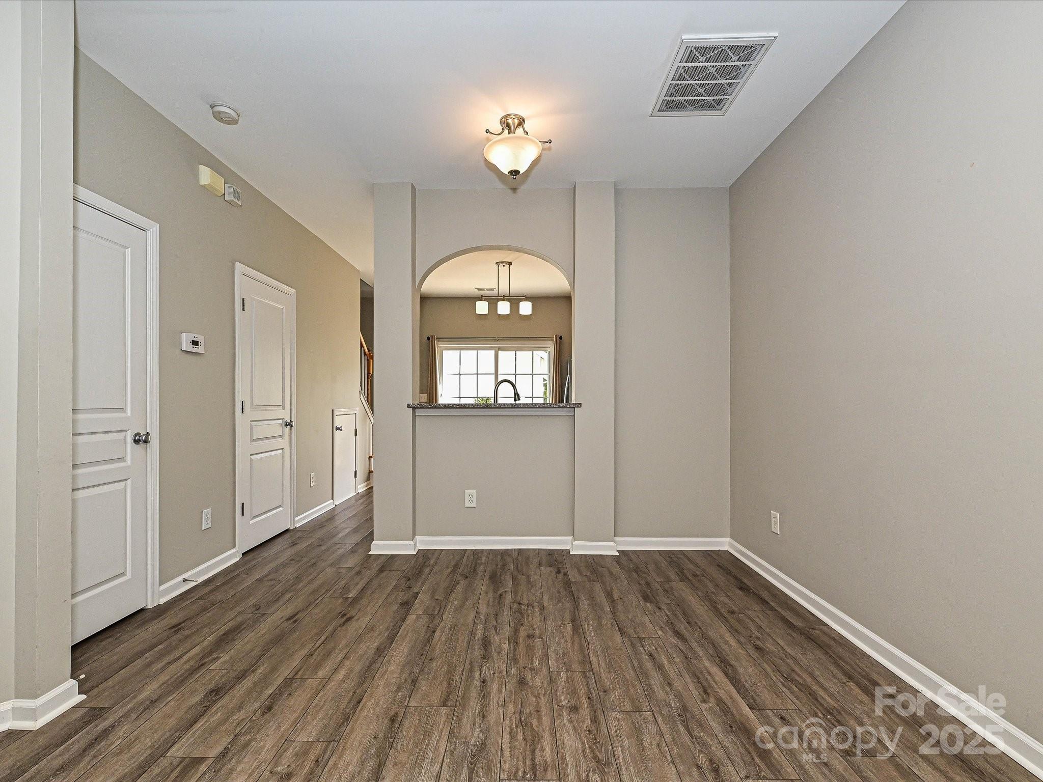 1115 Drummond Lane Matthews, NC 28104 - Photo 6 of 24 wooden floor in an empty room with a window
