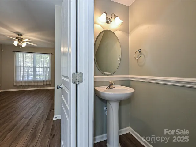 a bathroom with a sink mirror and toilet