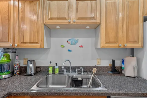 a kitchen with stainless steel appliances granite countertop a sink a stove and cabinets