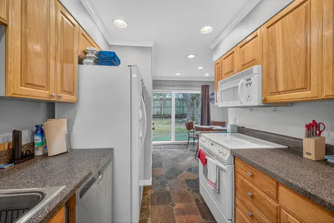 a kitchen with a sink a stove and a refrigerator