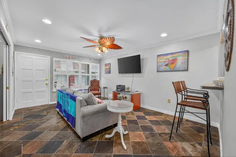 a living room with furniture a rug and a flat screen tv