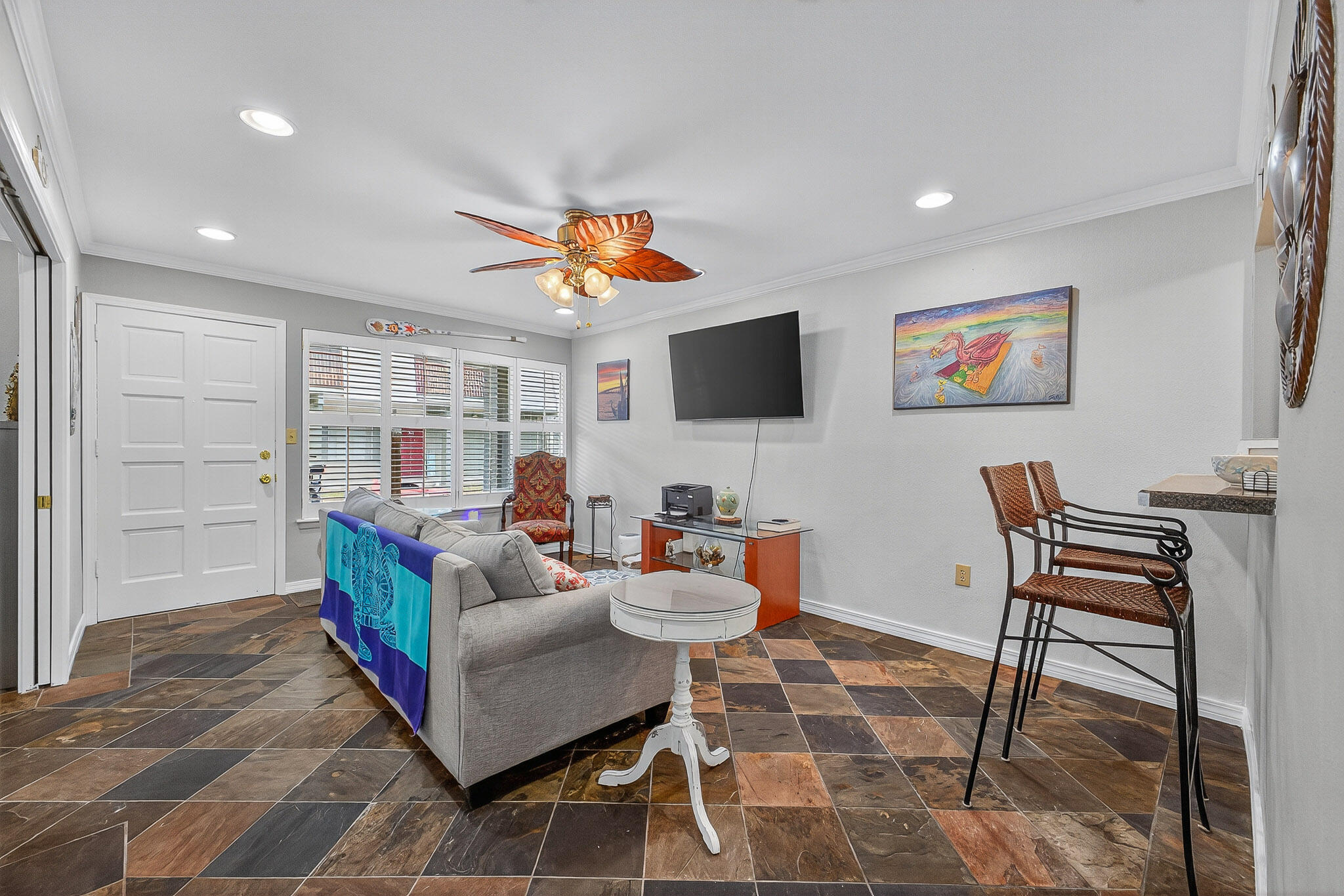 210 Pelham Road, Unit 104B Fort Walton Beach, FL 32547 - Photo 20 of 43 a living room with furniture a rug and a flat screen tv