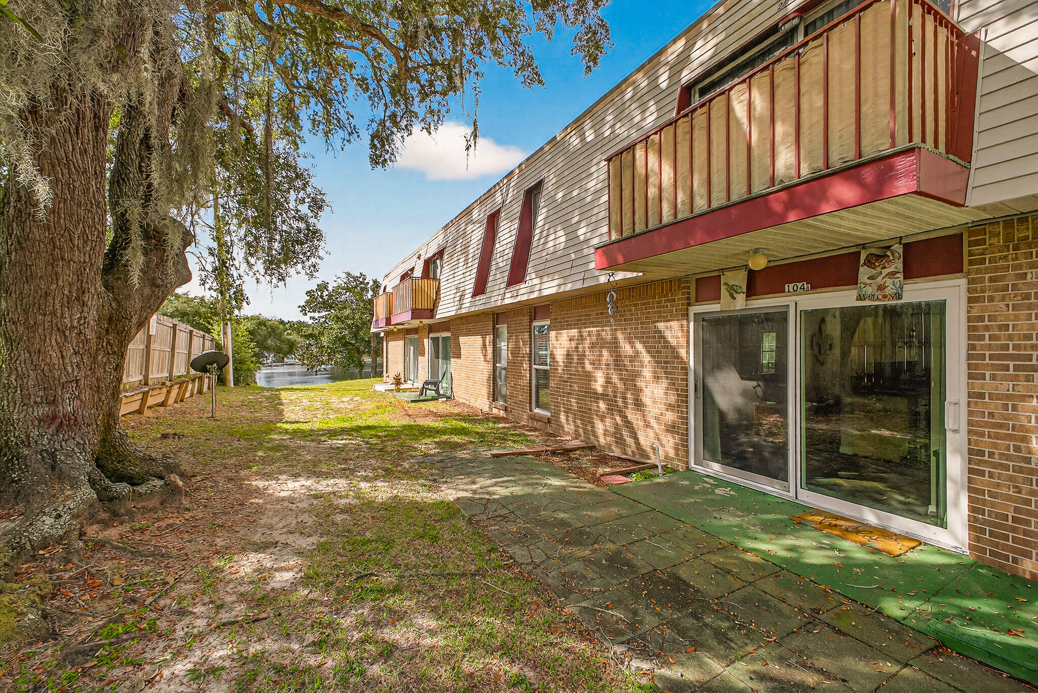 210 Pelham Road, Unit 104B Fort Walton Beach, FL 32547 - Photo 31 of 43 a view of a building with a yard