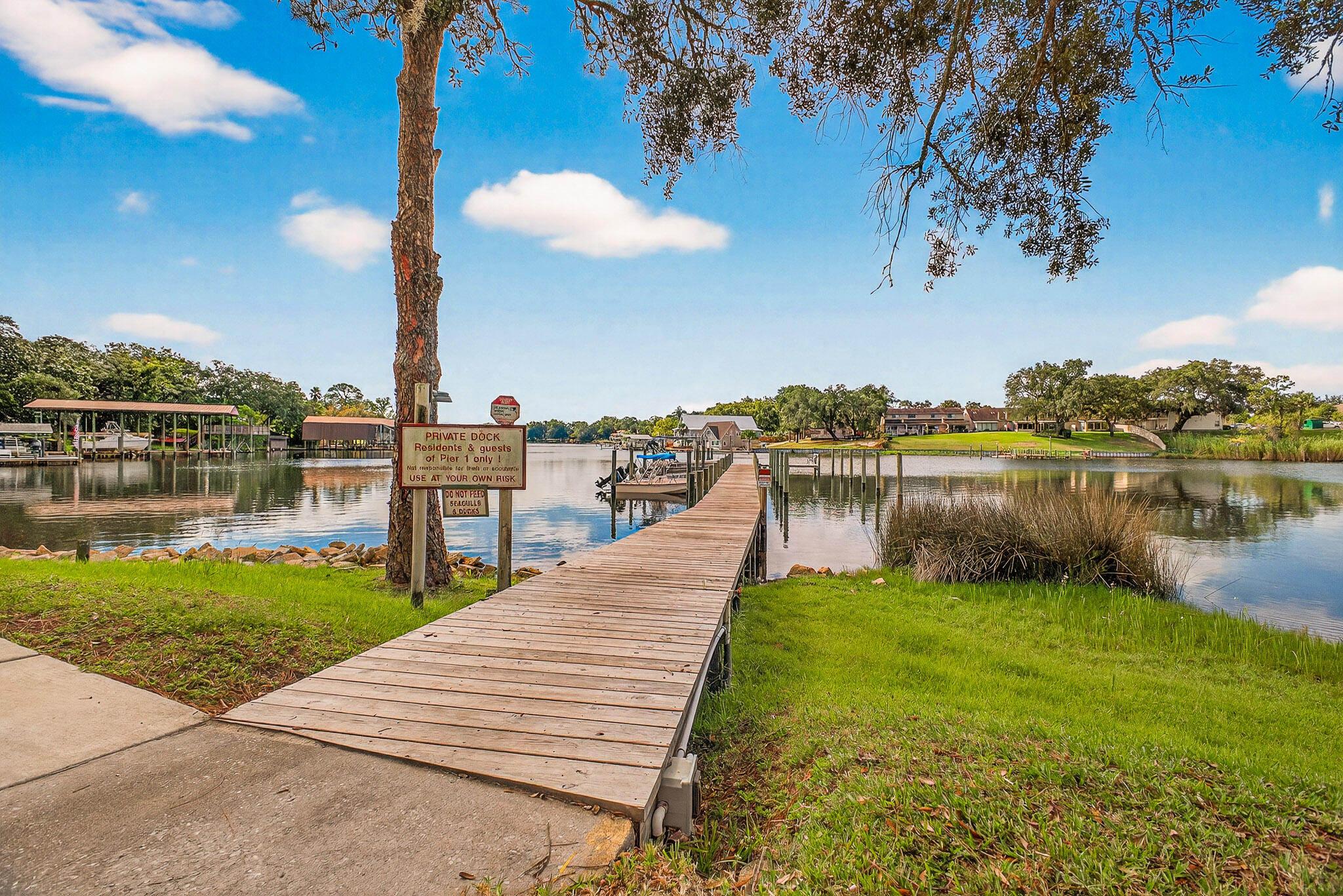 210 Pelham Road, Unit 104B Fort Walton Beach, FL 32547 - Photo 37 of 43 a view of a lake with a palm trees