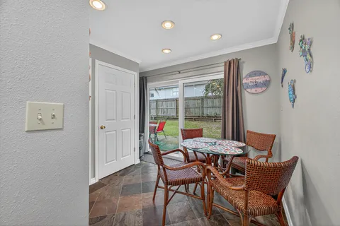 a view of a dining room with furniture and a window