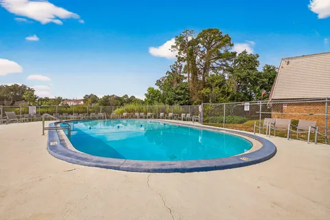 a view of a swimming pool with an outdoor seating and a yard