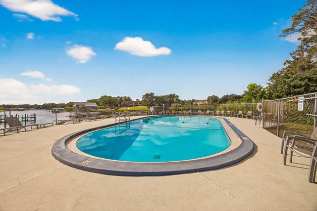 a view of a swimming pool with a table and chairs