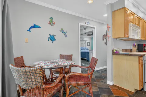 a dining room with furniture and a window