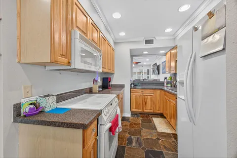 a kitchen with stainless steel appliances granite countertop a sink and cabinets