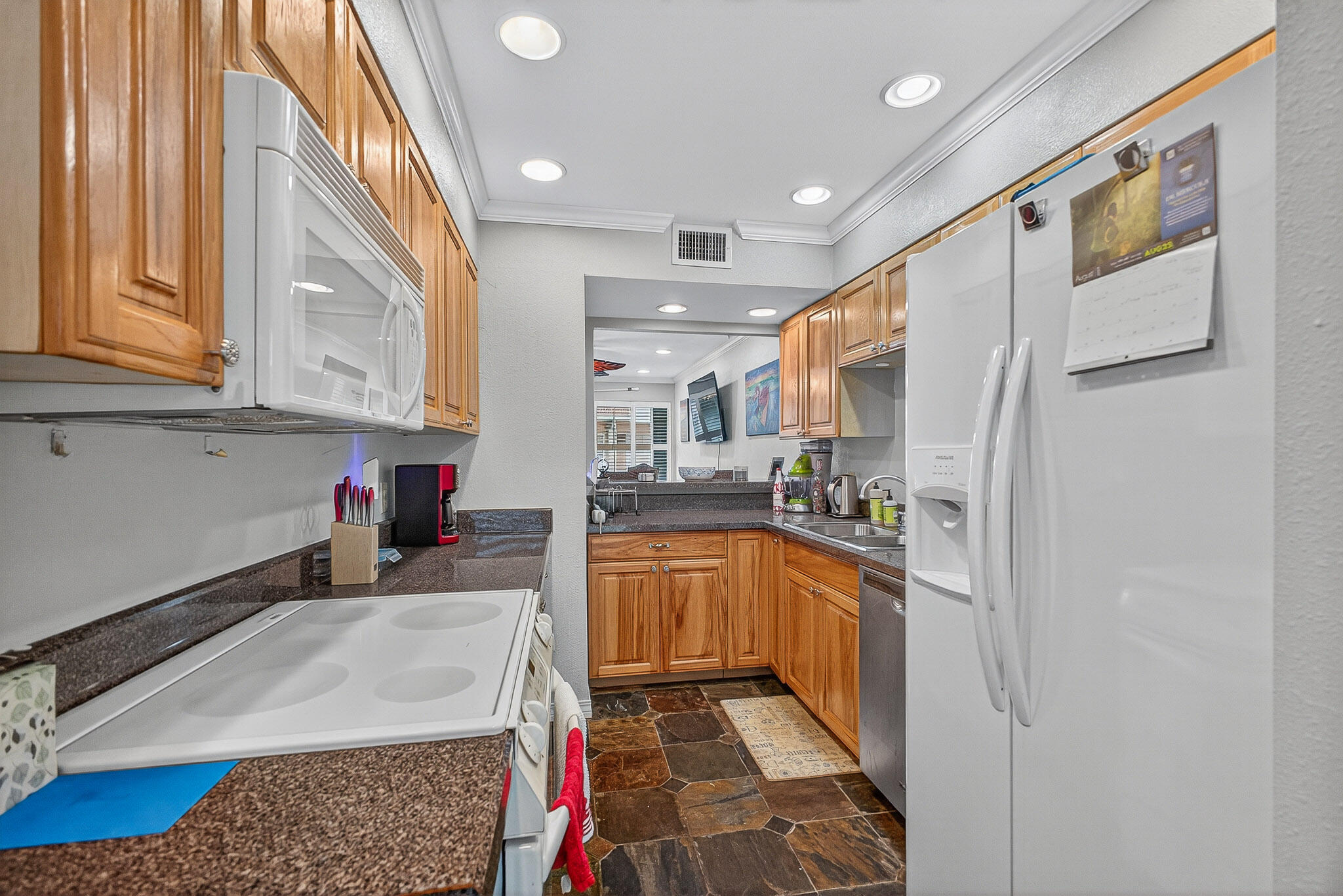 210 Pelham Road, Unit 104B Fort Walton Beach, FL 32547 - Photo 10 of 43 a kitchen with stainless steel appliances granite countertop a refrigerator and a sink