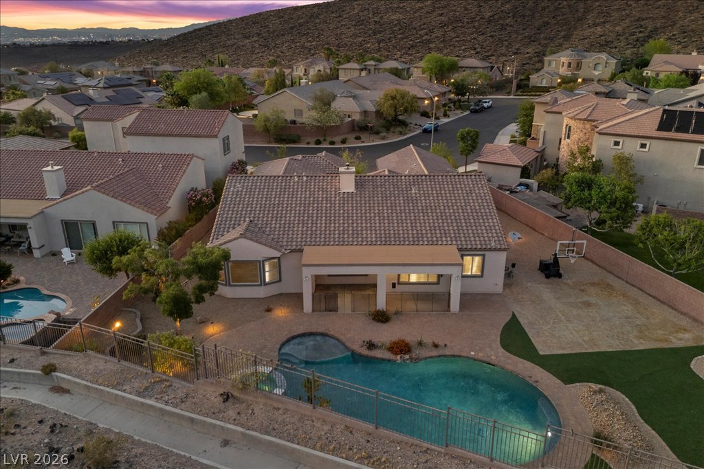 2125 De Rouge Avenue Henderson, NV 89044 - Photo 94 of 96 An aerial perspective reveals a serene backyard oasis featuring a custom pool, covered patio, and desert-adapted landscaping.