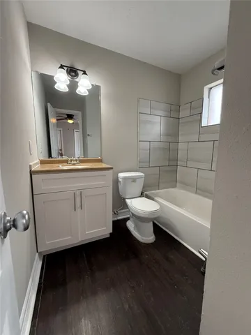 a bathroom with a toilet a sink and mirror