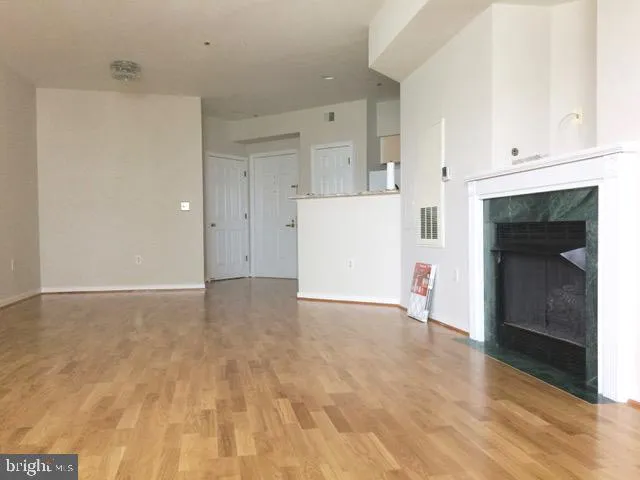 a view of kitchen and hall with wooden floor