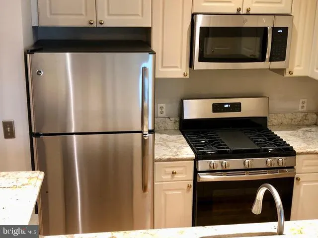 a kitchen with a stove and a microwave