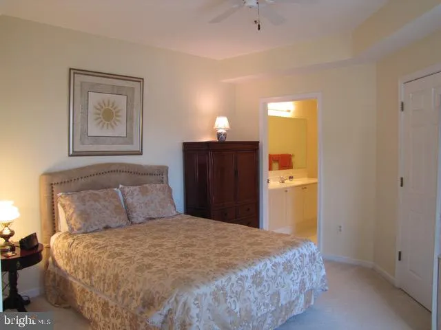 a bedroom with a bed and a lamp