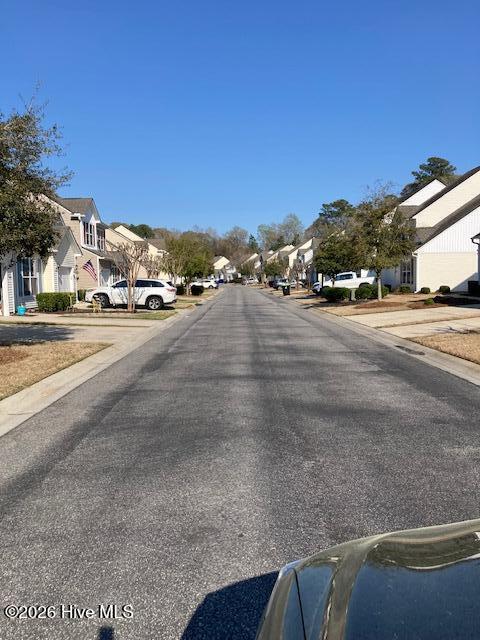 144 Freeboard Lane Calabash, NC 28467 - Photo 5 of 27 Tree lined neighborhood streets with Carolina blue sky