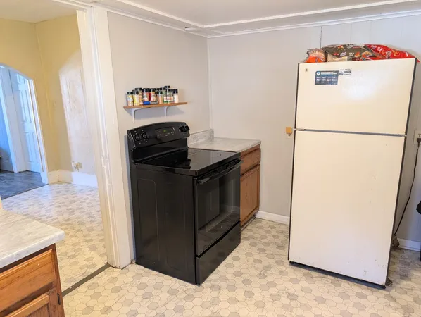 a kitchen with a refrigerator and a stove
