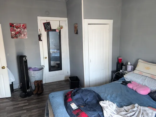 a bedroom with furniture and a wooden floor