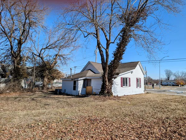 a house that has a tree in front of it