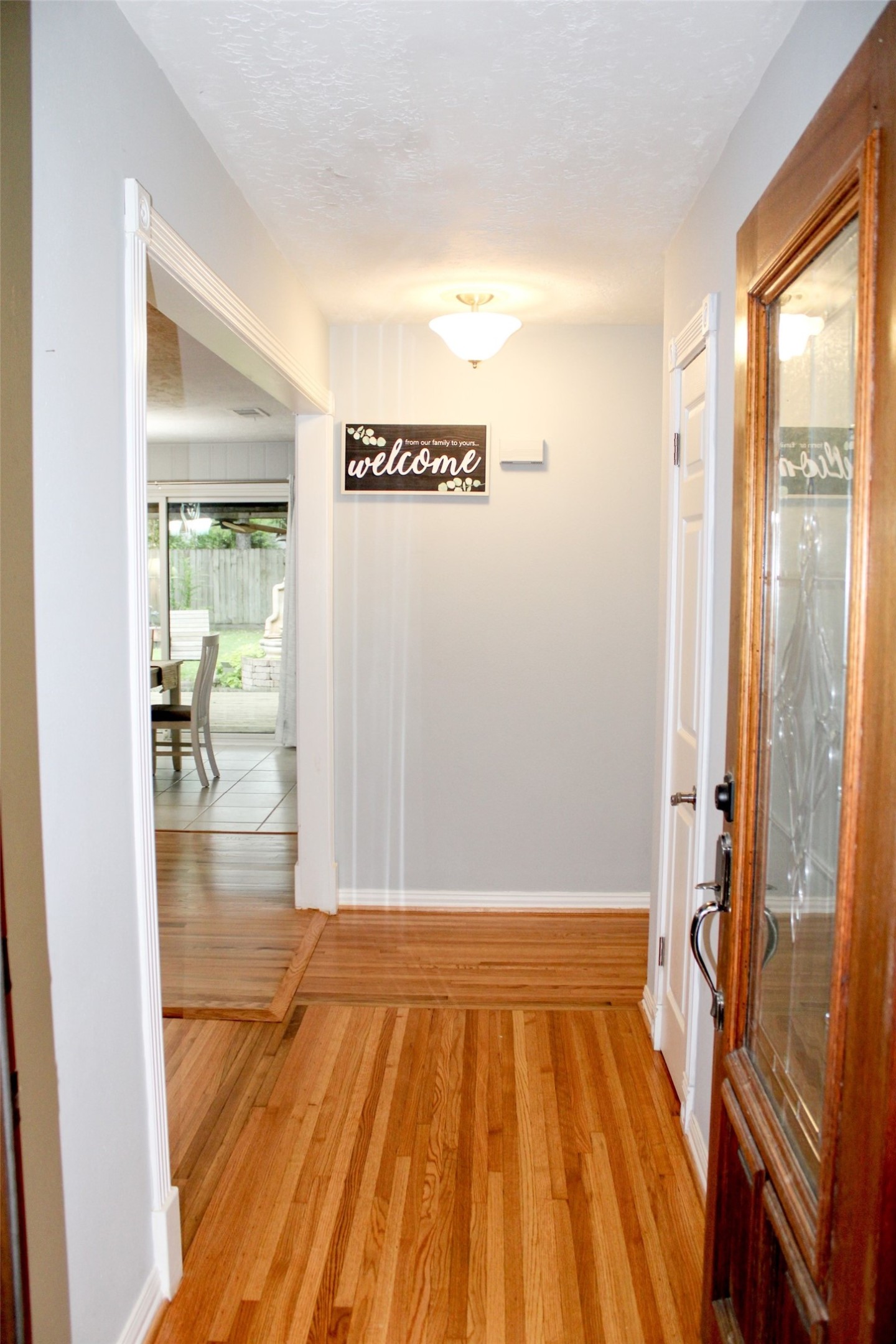 8910 Greiner Drive Houston, TX 77080 - Photo 3 of 21 a view of a hallway with wooden floor and a bathroom