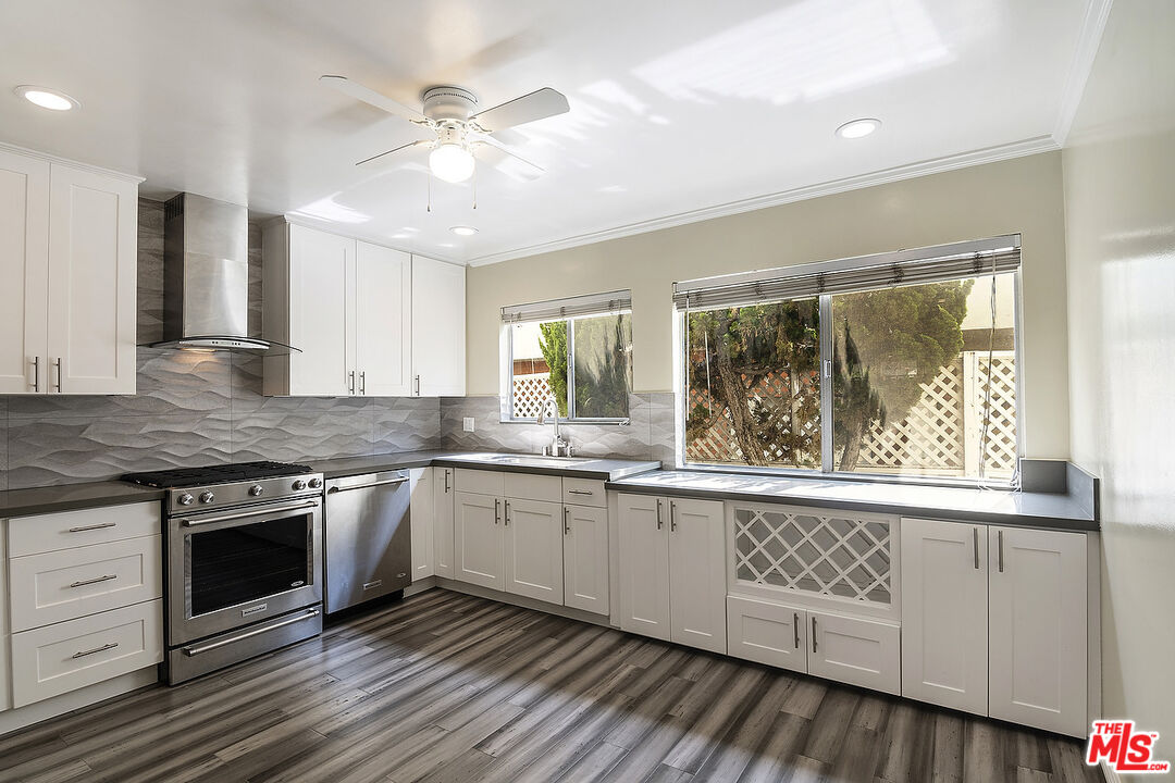 923 17th Street, Unit 3 Santa Monica, CA 90403 - Photo 11 of 22 a kitchen with stainless steel appliances granite countertop a stove and a sink